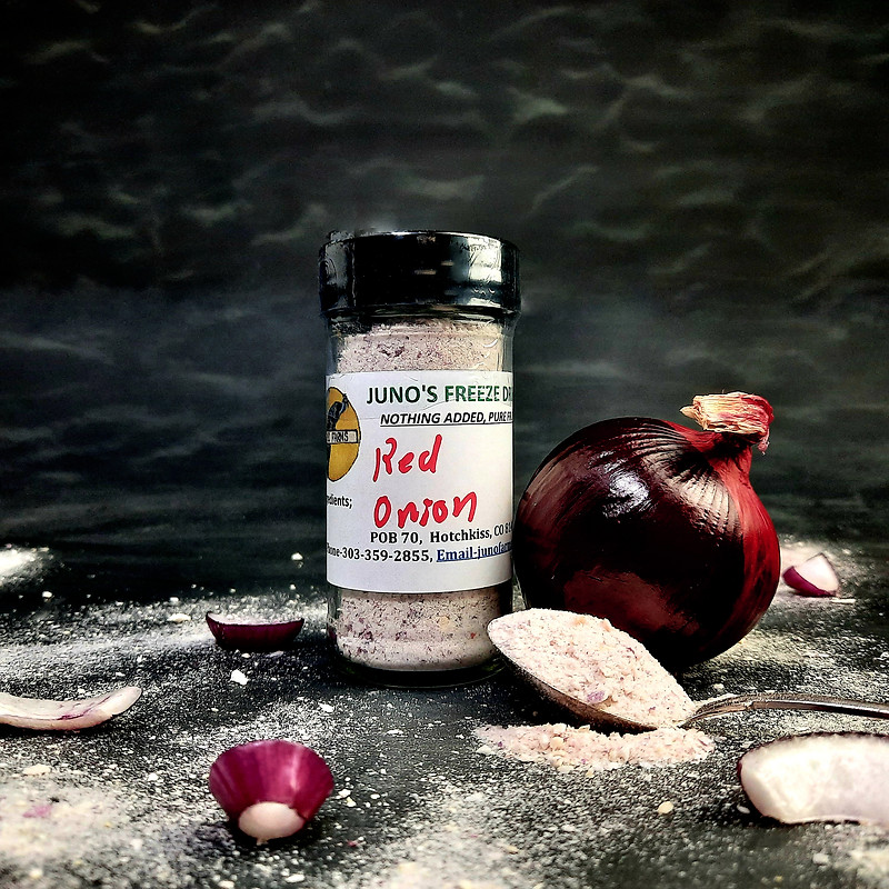Juno's freeze-dried red onion powder, hand-labeled jar beside a whole red onion